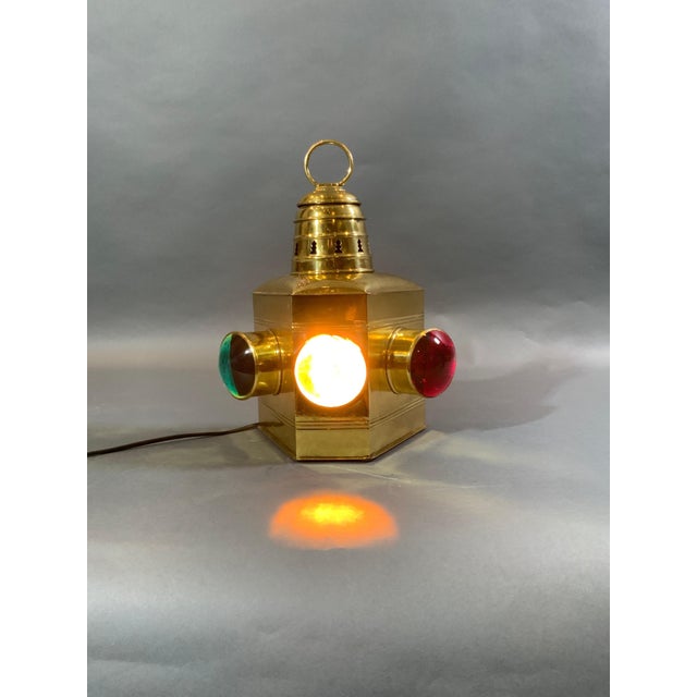 Polished brass boat lantern with three bulls eye lenses, red, green and clear. Highly polished. Fitted with a fresh socket...