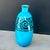 Elegant ovoid ceramic vase with a crackled turquoise glaze, adorned at the neck with a striking black spiral frieze. This...