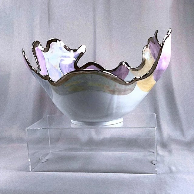 Large, organic form, contemporary fine art, ceramic bowl decorated with swaths of opalescent lavender, lilac, and peach...