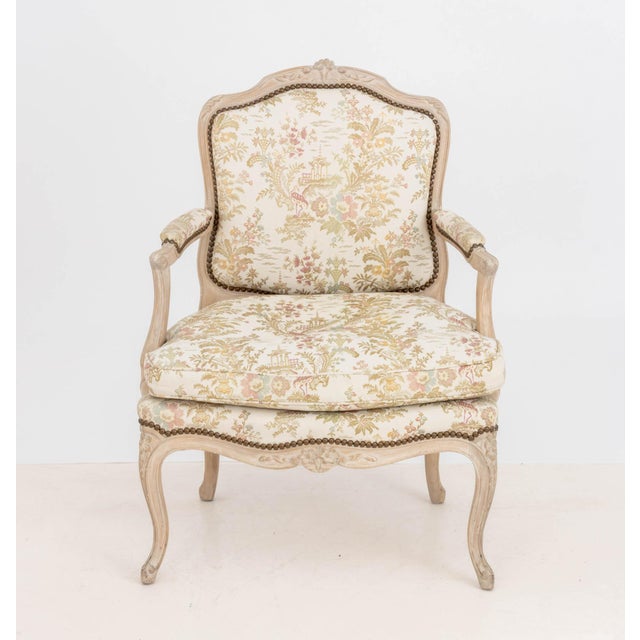 Louis XV Style Upholstered Fauteuil, the upholstered seat, arms, and back with Chinoiserie style pattern, the cerused wood...