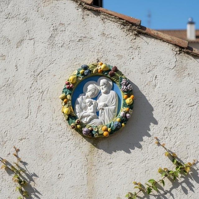 A charming hand crafted and painted majolica Italian wall plaque after legendary sculptor Della Robbia (1399-1482). Born...
