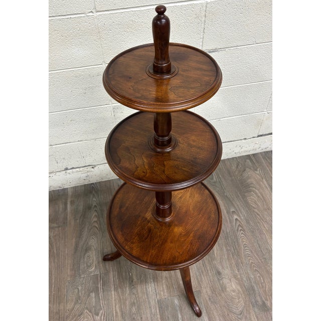 This is a gorgeous and unique late 19th-century Victorian or George III walnut revolving whatnot, dumbwaiter, or display...