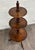 This is a gorgeous and unique late 19th-century Victorian or George III walnut revolving whatnot, dumbwaiter, or display...