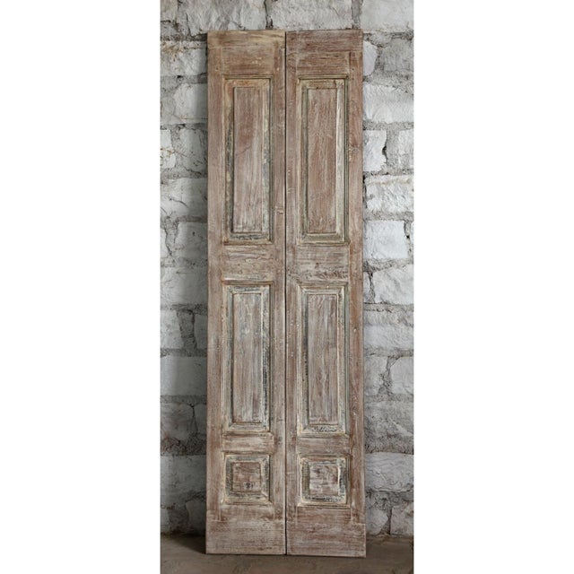 A breathtaking pair of antique French double doors crafted from reclaimed wood and adorned with intricate floral carvings....