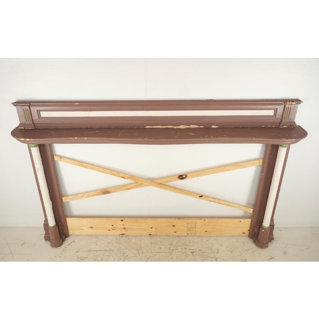Colonial Revival painted wood mantle with architectural detailing including pilasters with acanthus capitals. Painted in...