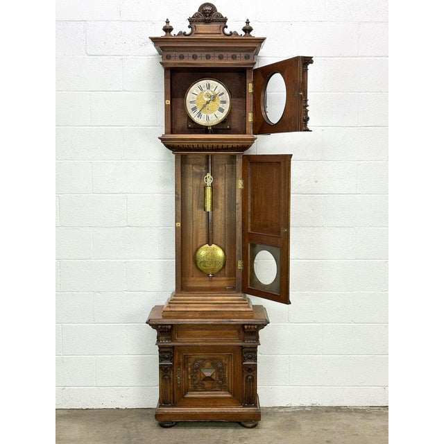 This listing is for a 19th century Austrian grandfather clock. The clock features a wooden case with ornate carved...