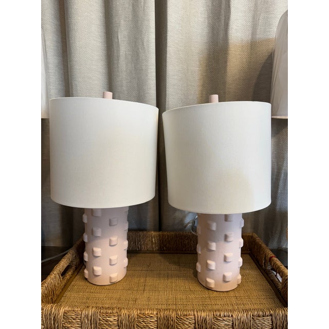 Pair of vintage pottery style lamps in opaque light pink. Included lampshades are made of white cotton fabric. Original...