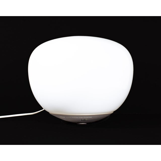 A "Jonisk" lamp designed by the Swedish designer Carl Öjerstam for Ikea. This lamp features an orb-like shape which rests...