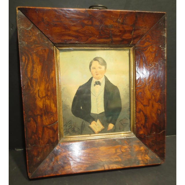 Classic portrait of a fine young man from the 19th century. Portly and well-dressed, holding a small book, likely a bible...