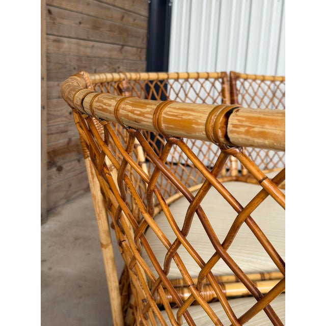 Insanely good and rare vintage three-piece rattan sectional featuring a beautiful curved center section flanked by two...
