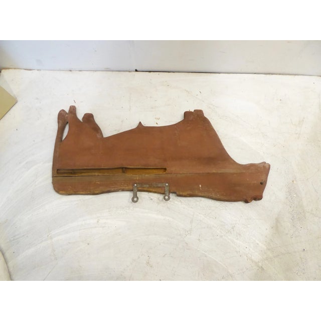 Folk Art cut out figure of bull, painted red.