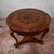This antique round table, dating back to the 19th century, embodies the elegance of period antiques through a perfect...
