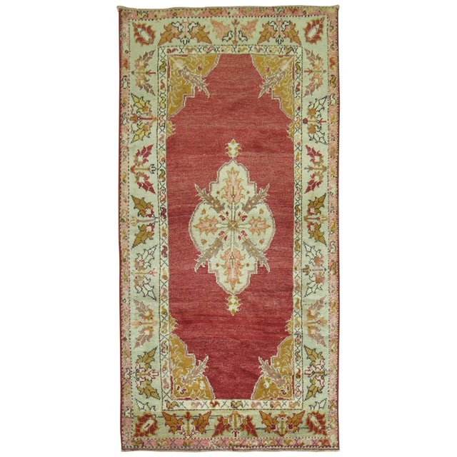 Fine quality early 20th century Turkish rug with a spacious red open field medallion design.