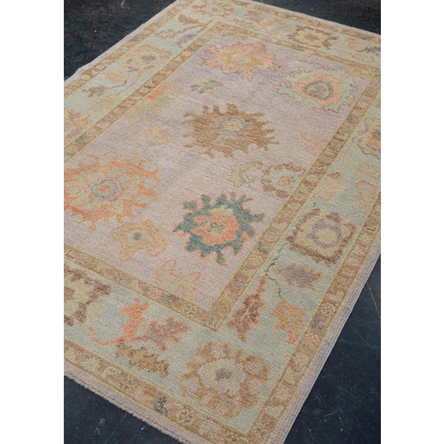Turkish Oushak Rug Lavender Coral Soft Brown Handwoven Wool Rug 4'2" x 6'1" This 4'2" x 6'1" Turkish Oushak rug presents a...