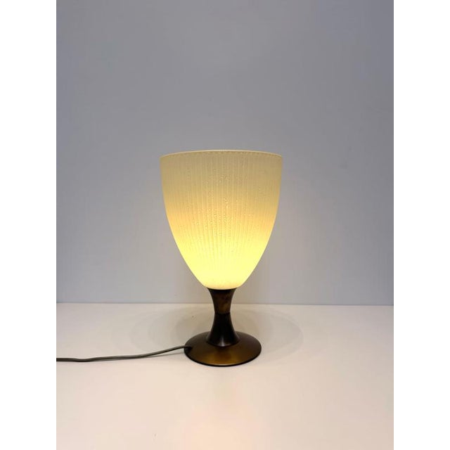 An elegant Italian table lamp by L.L. , featuring a beautifully handcrafted Murano-style textured glass shade mounted on a...