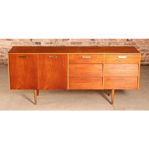 Mid Century teak sideboard by Avalon Yatton, circa 1960s. Brass handles and brass feet. 2 banks of 3 drawers and a cabinet...