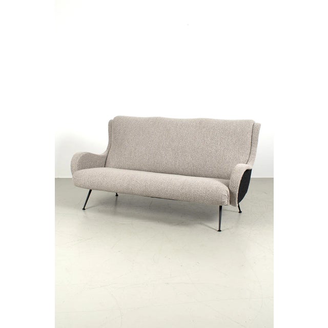 Amazing sofa from the 1950s, fully reupholstered with black and beige boucle fabric. The sofa includes two matching...