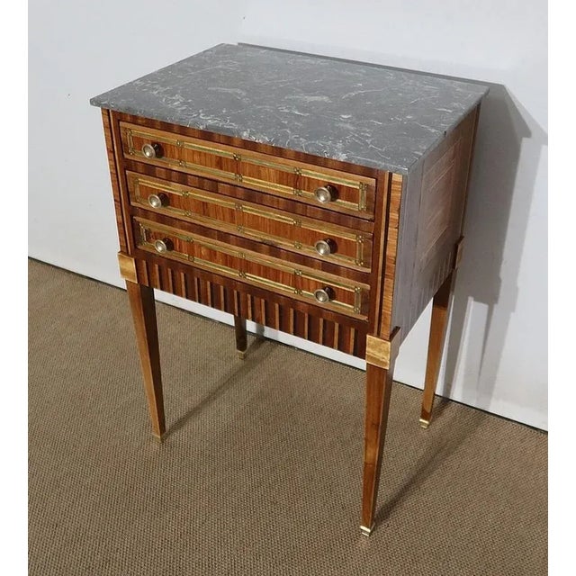 Beautiful small Louis XVI table in precious wood with an original grey marble top, veined with white. This elegant piece...