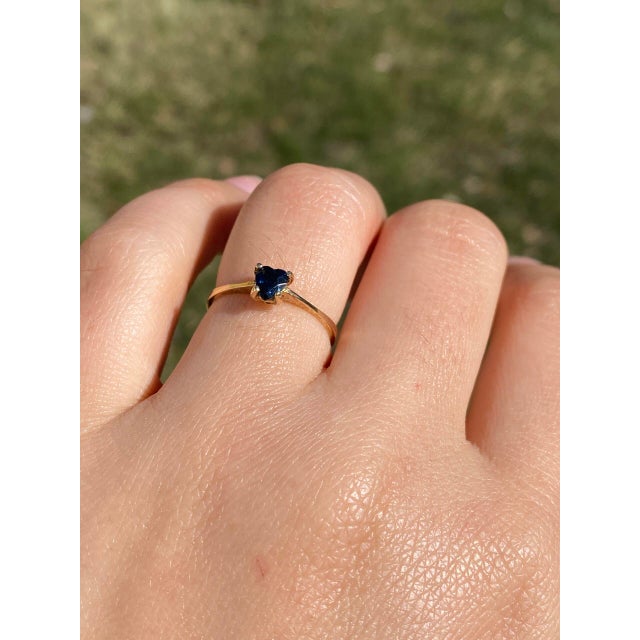 The Titanic: Natural Blue Heart Shaped Sapphire Ring in Yellow Gold. This simple ring centers on a midnight blue natural...