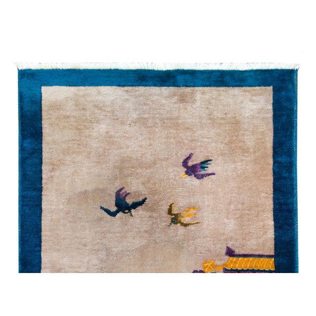 An early 20th century Chinese Art Deco pictorial rug depicting a scholar's garden landscape including a pavilion on one...
