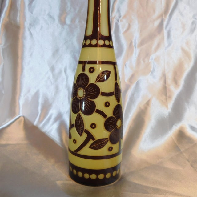 This is a tan over red cut to clear glass decanter with a stopper that is only red but matches the design and it fits...