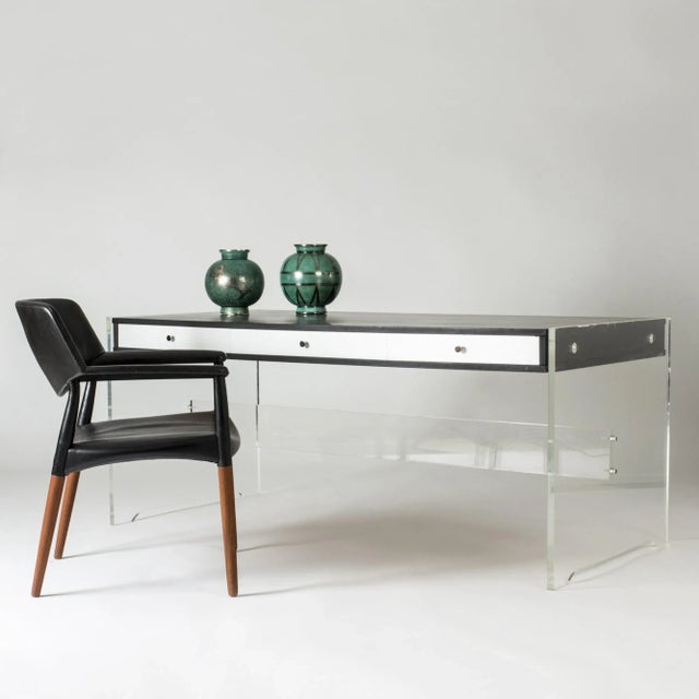 Striking desk by Poul Nørreklit, made from plexi glass with a lacquered wood table top and drawers. Thick, translucent...