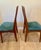 Stunning and rare set of two teak chairs from famed Danish designer Benny Linden. It has the classic railback style of his...