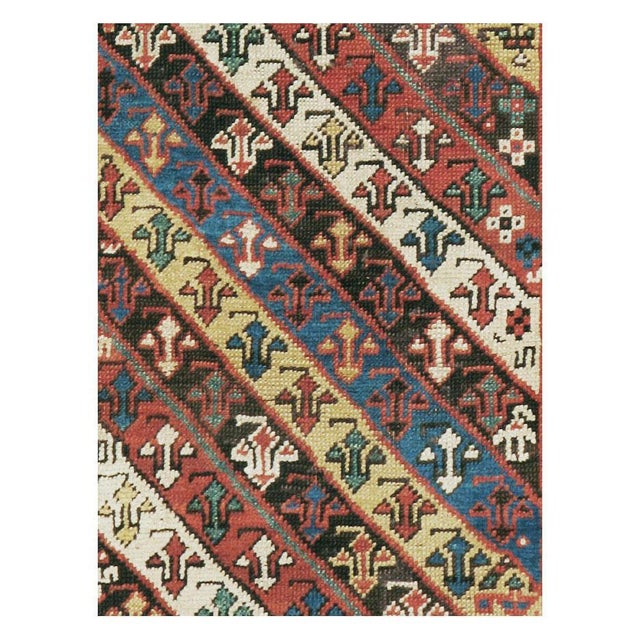 An antique Caucasian Kazak rug in runner format handmade during the early 20th century with a geometric tribal design....