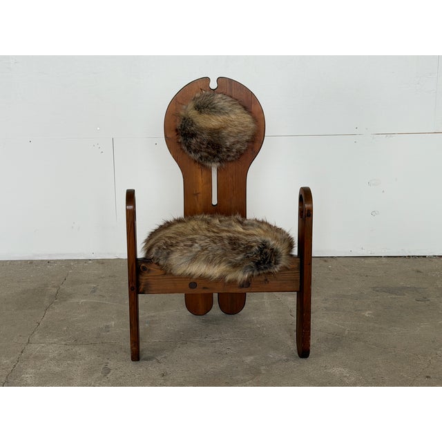 This sculptural lounge chair is stamped "Design Szedleczky" to the top of the chair, and was produced in solid pine,...