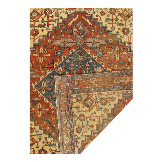 Aantique Heriz Serapi Rug, the brilliant red field bears a central Ray of Life and many highly abstracted geometric shapes...