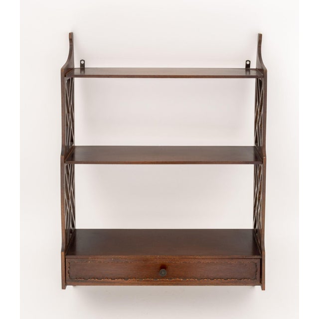 Chippendale Style Mahogany Wall-Hanging Shelf, with two shelves above a single drawer and fretwork sides. 28" H x 20.25" W...