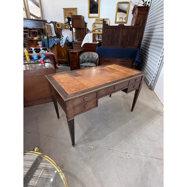 fine French Louis XVI style writing desk with a brown leather writing surface. the desk made of solid mahogany, the wood...