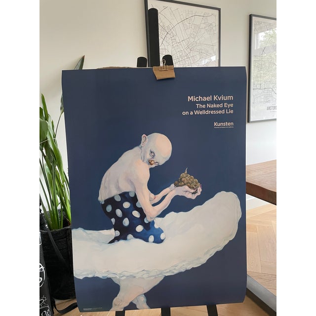 This Michael Kvium poster, The Naked Eye on a Welldressed Lie III (2012), explores themes of death, human urges, and...