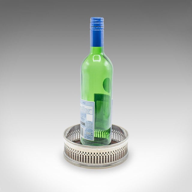 This is a large diameter antique wine bottle coaster. An English, silver plate and walnut decorative Champagne Jeroboam...