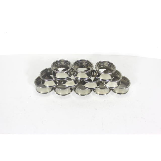 Beautiful set of 12 vintage silver plated metal napkin rings with beaded edges. Excellent vintage condition. They have...