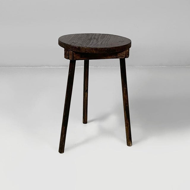 Italian 19th century style table stool in wood, 1930s Dark wood table stool. The round seat is supported by three round...