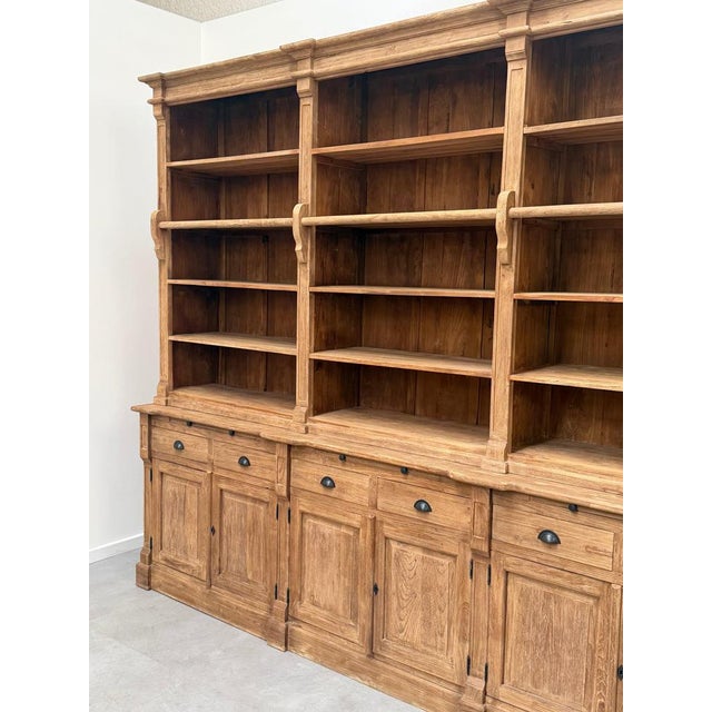 Impressive large-scale antique style bookcase cabinet crafted from high-quality recycled teak wood. This stunning...