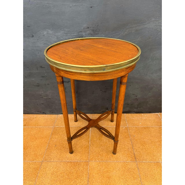 Elegant French gueridon table in the Louis XVI style, dating from the 20th century. The table features a circular wooden...