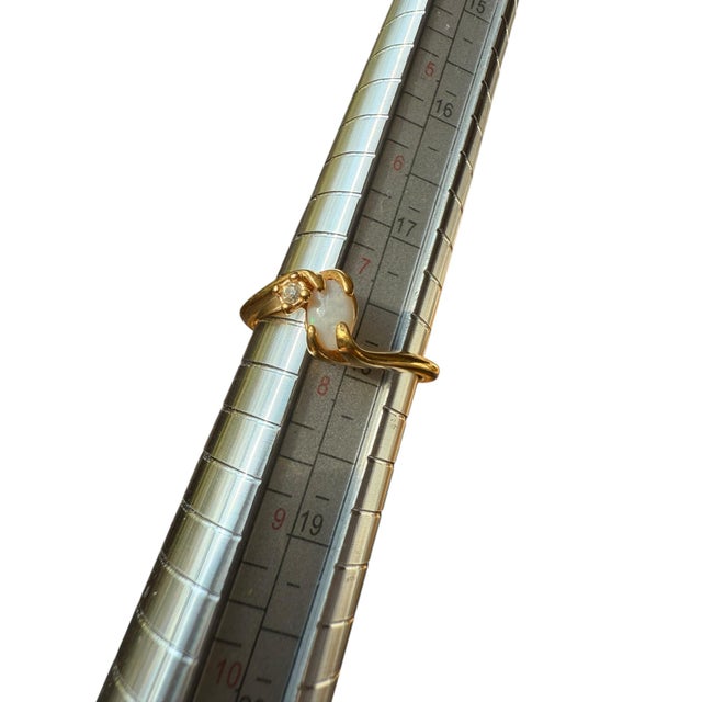 Opal in Gold Plated setting with rhinestone accent. Size 7.5-7.75 Marked 18 KT. HGE (Heavy Gold Electroplate)