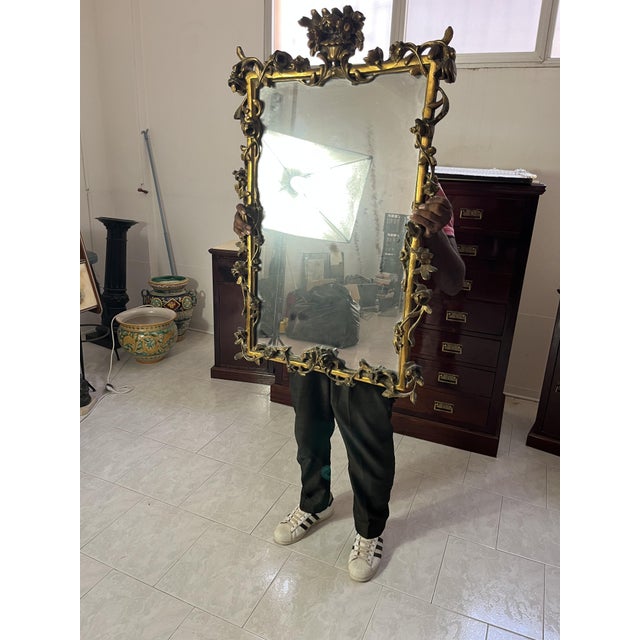 French carved wooden wall mirror with gold finish, 1930s Good condition, with minor signs of wear. Found in a noble villa...