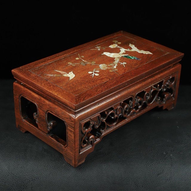 A beautifully crafted Chinese rectangular display stand or low table, likely made of Huali (rosewood). The piece features...