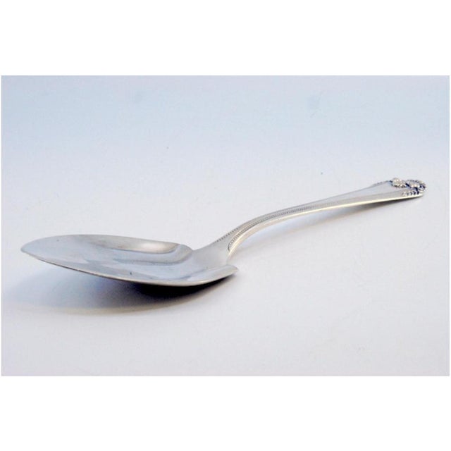 Silver Vegetable Spoon with Reliefs on the Shell and Grooves, in Very Good conditions. Designed 1920 to 1949 This piece...