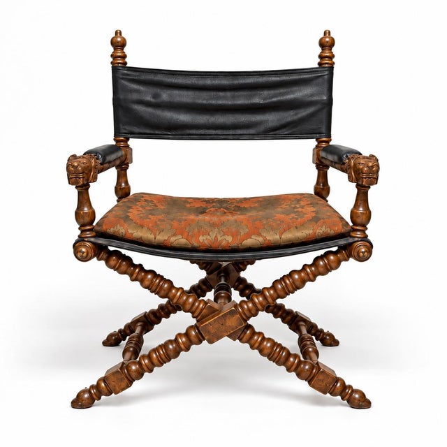 This is a pair of campaign style leather carved walnut bobbin x-frame director’s chairs attributed to Marge Carson. They...