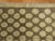 A mid-20th century Turkish Konya Intermediate size rug with repetitive circular motifs running on a brown colored ground....