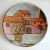 This flat ceramic wall plate depicts a landscape. It retains its Italica ARS label and is signed Lazzaro.