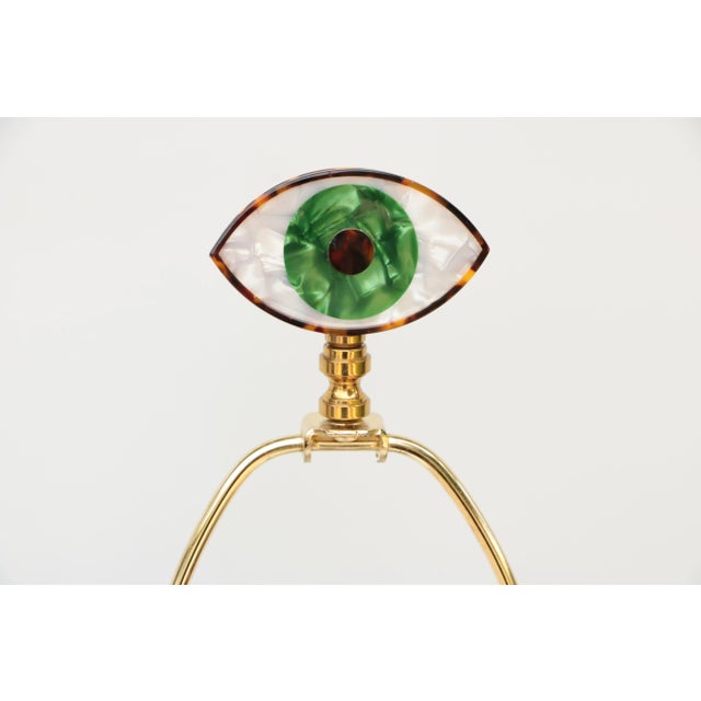 Update your favorite lamp with this green eye lamp finial crafted from an acrylic eye mounted on brass hardware. This eye...