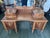 A Depression-era American vanity in walnut and burl walnut veneers, with drawer fronts and accents in quilted maple. The...