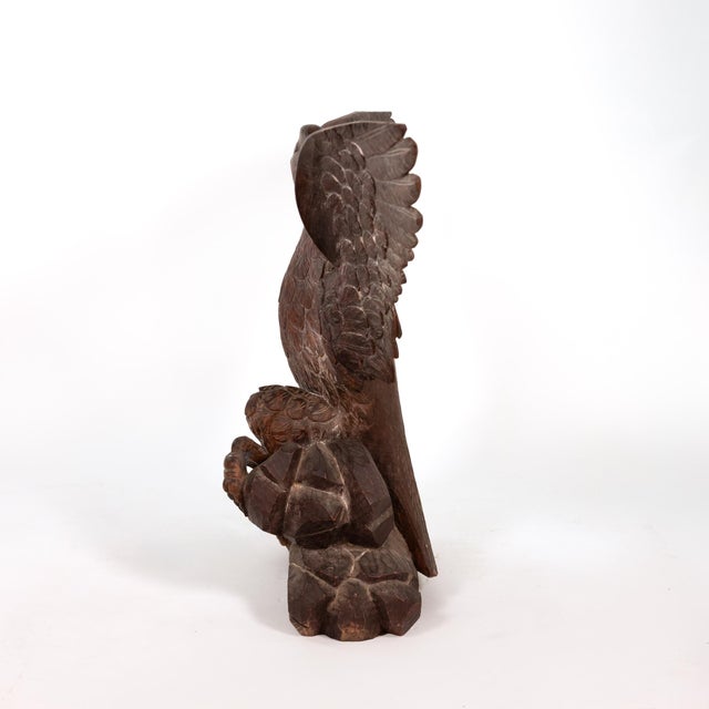 Large carved oak sculpture modelled as an eagle displayed, with wings fully outstretched, the head turned and beak open,...