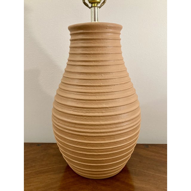 Terra cotta paint over classic plaster lamp. 16" tall to the top of the urn 28" tall to the top of the harp 10" diameter...