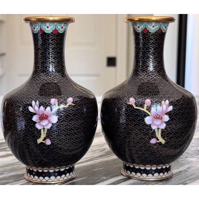 Here is a pair of stunning cloisonné vases featuring early spring blue tree blossoms on the front and pink blossoms on the...
